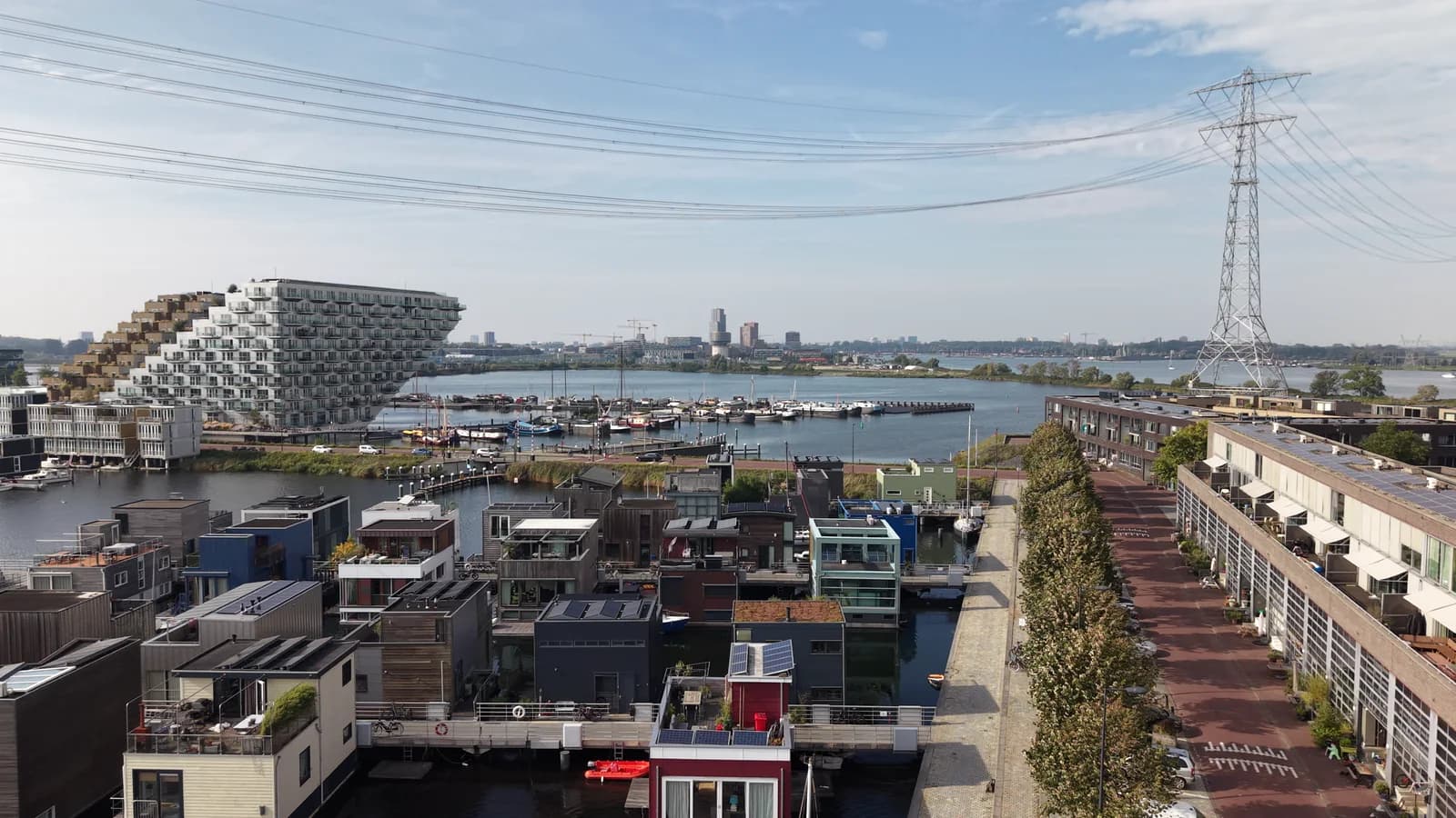 Modern homes and waterways in IJburg, filmed from the air.